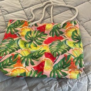 Light weight canvas beach bag with rope handles. Snap closure.